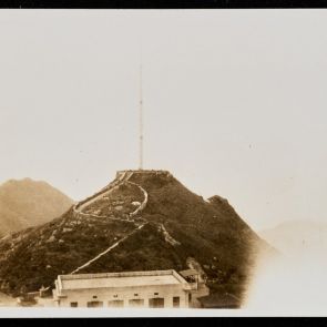Observation deck and radio tower on a rocky, bushy rooftop