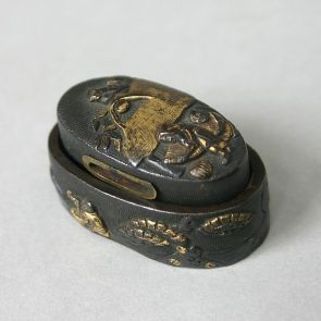 Fuchi with a scene depicting a man filling rice sacks in front of his hut