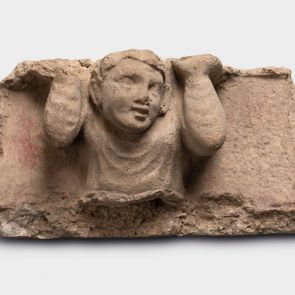 Ledge-holding youth. Frieze fragment.