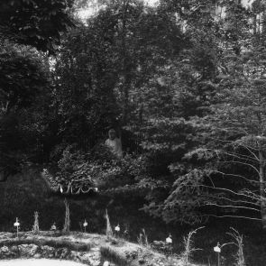 The garden of the Hopp villa in Andrássy út, with a sitting Buddha among plants and a huge seashell