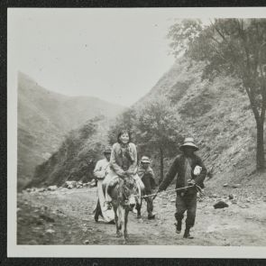 Chinese tourist riding a mule with a guide, Nankou Pass, near Beijing, May 31, 1936
