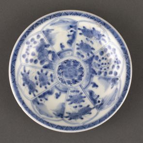 Saucer decorated with landscapes and floral motifs in radially arranged panels