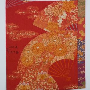 Japanese obi design sample with golden fans in front of dark pink background