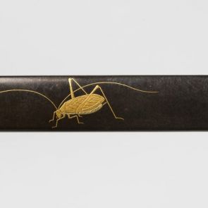 Kozuka knife handle decorated with suzumushi (bell cricket) and an openwork chrysanthemum motif