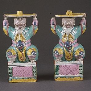 Figural candleholder of a pair