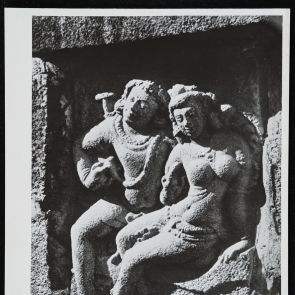 Smiling man and woman sitting next to each other - black and white photo