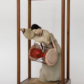 A young woman playing the drum