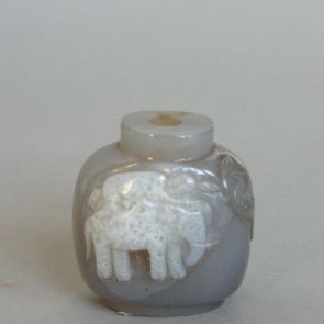 Snuff bottle decorated with a man lying on an elephant