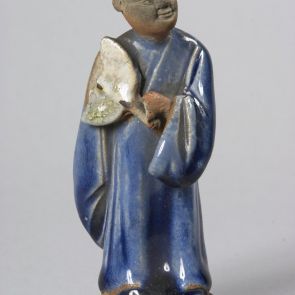 Male figure with a tail of hair and a fan