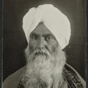 Self-portrait with embroidered border blanket on shoulder