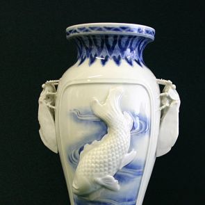 Blue and white baluster vase with the raised motif of a carp and a dragon, and decorated with two handles in the shape of cicadas