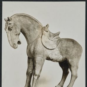 Horse with saddle, white earthenware, pale yellow glaze