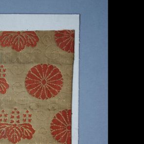 Textile sample - Coral red chrysanthemums, leafs, and shoots, woven with gold thread, against mustard yellow background