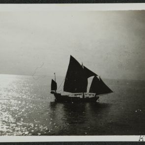 Departure from Shanghai, a sailboat in the backlight