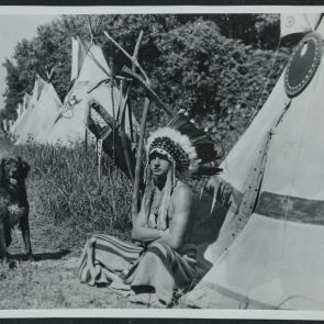 "Manydogs" (Ernő Gottesmann) with his dog named Rancher, in front of a teepee