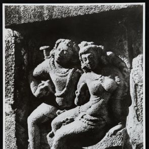 Smiling man and woman sitting next to each other - black and white photo