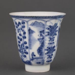 Cup decorated with landscapes and floral motifs in radially arranged panels