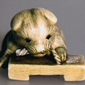 Netsuke: Puppy playing with a wooden sandal (geta)