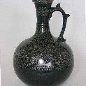 Black vase with handle and silver ornaments
