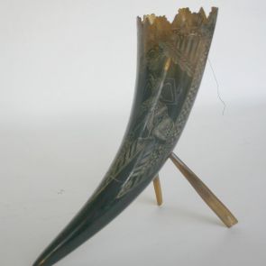 Ornamental object carved of horn, decorated with wayang figures