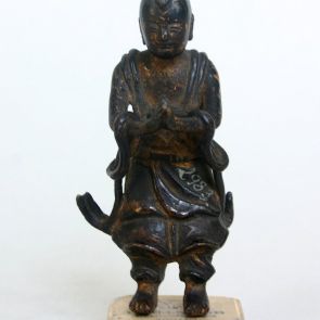 Standing attendant figure in a gesture of prayer