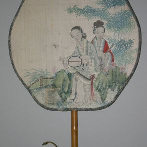 Fan with the picture of two ladies sitting beneath bamboo