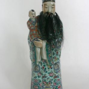Standing deity of good luck with a child