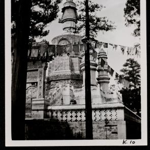 The stupa and foundations of Huang-se Monastery are covered in marble (with votive flags along the road)