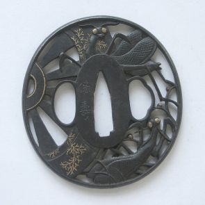 Tsuba (sword guard), decorated with praying mantises trying to escape from the wheels of a carriage