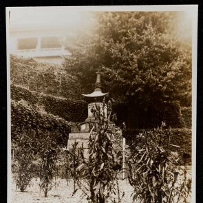 Stone lamp on a wide stone base in the museum garden, Okura Shukokwan, Tokyo