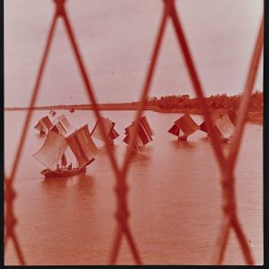 Sailing boats on the water, photographed from behind a fence - North Vietnam