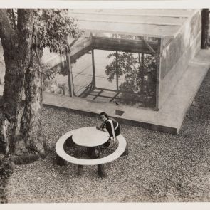 Amrita on the round bench in front of the bath, photographed from above