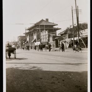 Main road with rickshaws and partly traditional-style buildings