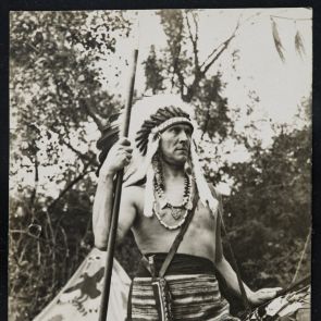 Indian chief Ervin Baktay wearing a dagger in front of a tent