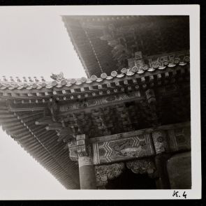 Traditional roof structure at the corner of the building (support beams, brackets, ridge tiles)
