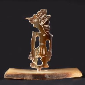 Tiny wayang figurine with pedestal