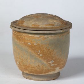 Lidded jar with worn glaze
