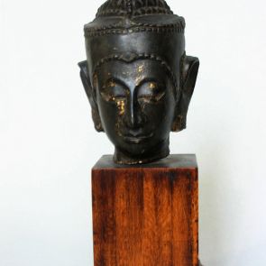 Buddha head on a wooden stand