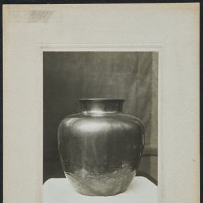 Convex vase with maple leaves floating above a river