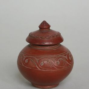Small reddish brown lidded pot with encarved decoration