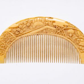 Comb with pines, an ornate carriage and cherry blossom