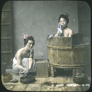 Japanese women take a bath in a heated wooden bathtub