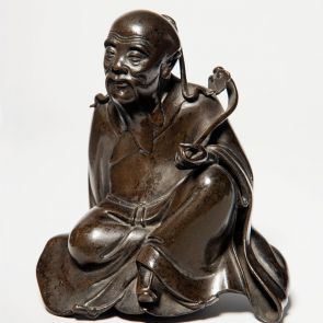 Sitting male figure with sceptre in his hands