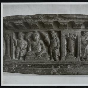Black and white photo of Buddhas with disciples, relief detail