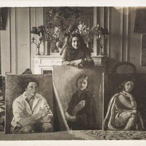 Amrita in the salon of their home in Paris, with her paintings