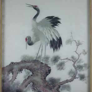 Pair of cranes on a pine bough