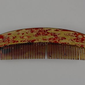 Ornamental comb (sashi-gushi) with decoration of a resting peasant among flowers on a field