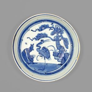Blue and white plate with crane and pine