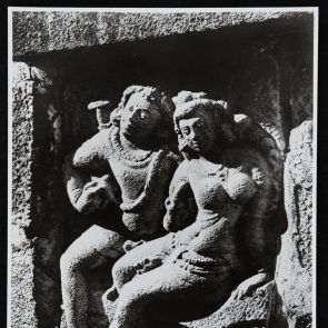 Smiling man and woman sitting next to each other - black and white photo