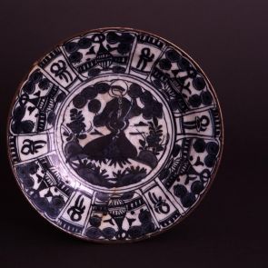 Plate with radiating panels and a female figure